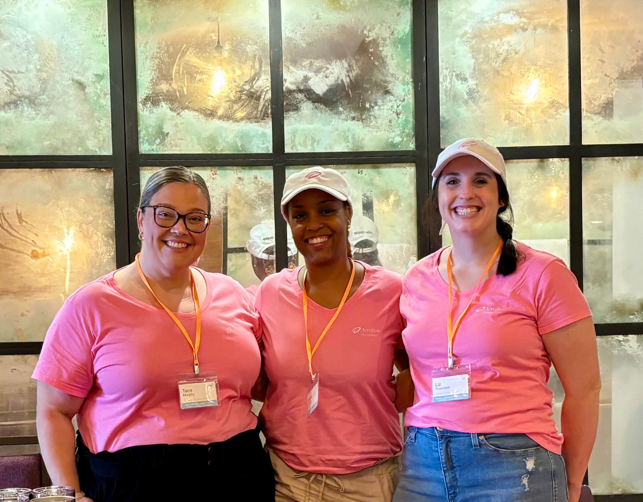 Team members in pink shirts at a Lactivents event