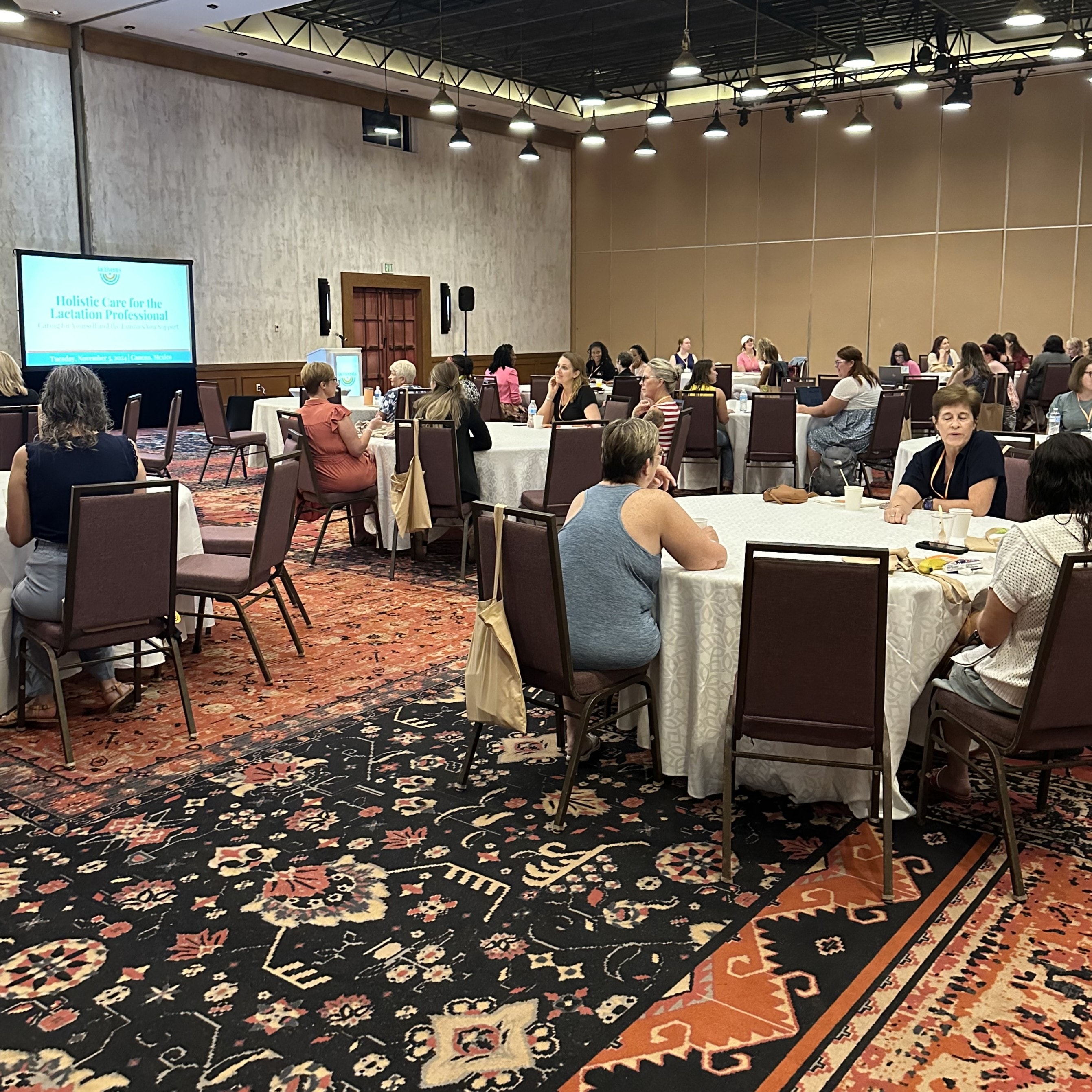 Conference attendees seated at round tables